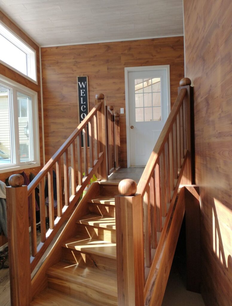 Traditional wood staircase with matching wood railings and balusters
