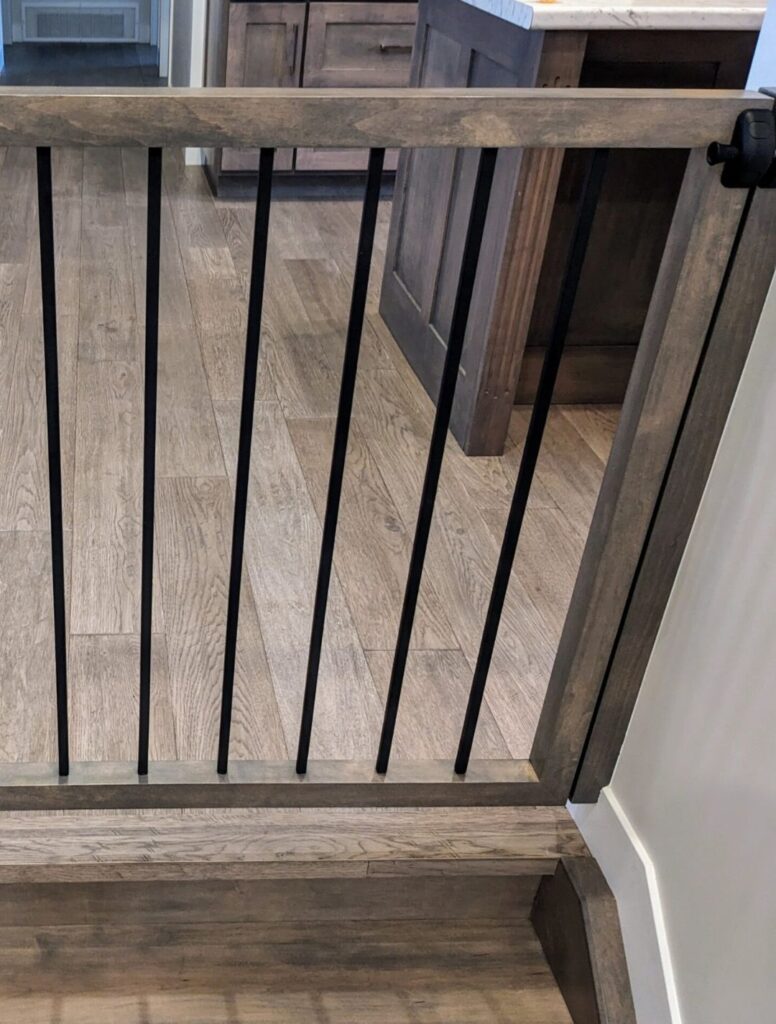 Close-up of dark wood railing with black metal balusters
